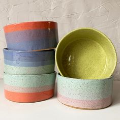 three bowls stacked on top of each other with one bowl in front of the other