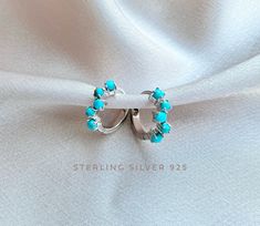 Genuine Turquoise Hoop Earrings made of Sterling Silver. High quality, and very precious. They are also available in Rose Gold over Sterling Silver and 18K Gold over Sterling Silver (925). Hoop thickness 1.5 mm, Outer Diameter: 1.4 cm. Inner Diameter 1 cm Stone: 5 small Genuine Turquoise , Size approximately 2 mm. **They come in pairs. We offer a free gift wrap option upon request. Just leave me a note at checkout saying that you would like your order gift wrapped. Our shop creates trendy design Blue Hoop Earrings For Wedding, Handmade Blue Huggie Hoop Earrings, Turquoise Hoop Earrings As A Gift, Turquoise Gemstone Hoop Earrings, Turquoise Hoop Earrings For Gift, Handmade Round Huggie Earrings For Wedding, Handmade Huggie Earrings For Wedding, Elegant Turquoise Huggie Earrings Gift, Elegant Turquoise Hypoallergenic Hoop Earrings