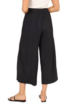 These flowy, culotte-style pants have an elastic waist and pleated design so you move with ease every day whether you're going out or enjoying a day at home. Elastic waist Unlined 100% polyester Hand wash, dry flat Imported Casual Bottoms With Pleated Waist For Day Out, Spring Bottoms With Pleated Waist For Day Out, Pleated Stretch Bottoms For Day Out, Casual Black Bottoms With Pleated Waist, Spring Relaxed Fit Pleated Bottoms, Black Elastic Waistband Culottes For Spring, Relaxed Fit Wide Leg Bottoms With Pleated Waist, Versatile Black Culottes For Spring, Black Pleated Pants For Spring