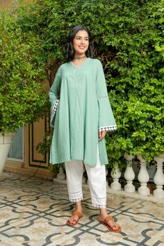 Stella green ash kurta with pant set is perfect for a festive season or a day out . Cotton cambric fabric makes it perfect for summer weather. Front diamond cut neckline with kurta hem lace give a classic look. Product has no lining. Pant has two side pockets, back elasted waistband and lace on the hem. Cold wash and Dry clean only.Type of Work: Solid Fit: Loose Model Height: 5'7 Measurements: Kurta- 41.5" Pant- 35.25" SKU#: 11702070GR Disclaimer: There may be slight difference in actual product Solid Kurta Set, Green Cotton Kurta For Summer, Summer Green Cotton Kurta, Casual Cotton Kurta With Dabka Work, Green Cotton Anarkali Kurta, Loose Kurta For Women, Casual Salwar Kameez With Dabka, Green Cotton Kurta For Spring, Green Anarkali Kurta For Summer