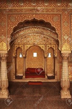 an elaborately decorated room with red carpet and pillars