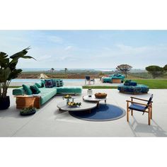 a living room filled with furniture next to a pool