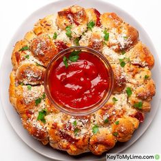 a white plate topped with pizza covered in sauce