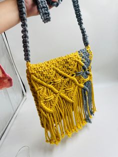 Add a different accessory to your wardrobe, make a statement with this eco-friendly Macrame Sling bag while feeling confident you are helping your earth.  Natural, simple and in Mustard & grey and creamy white this unlined bag is handcrafted by artisans in India from up-cycled cotton denim and recycled material in intricate knotted patterns in the macrame style. Tie the shoulder strap to your desired length. Customisable in any color. Size- Width- 9.5 Inches, Length- 9.5 Inches. Please let me know if you have any questions regarding any of my product. Eco-friendly Macrame Tote Shoulder Bag, Eco-friendly Macrame Bag For Everyday Use, Everyday Rectangular Macrame Shoulder Bag, Bohemian Macrame Shoulder Bag, Everyday Bohemian Macrame Shoulder Bag, Eco-friendly Macrame Shoulder Bag For Daily Use, Eco-friendly Macrame Crochet Bag For Everyday Use, Eco-friendly Macrame Shoulder Bag, Everyday Macrame Crochet Crossbody Bag