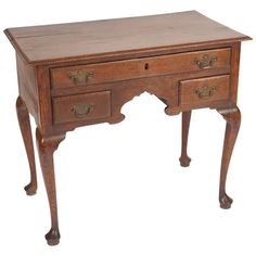 an old wooden desk with two drawers on one side and a drawer on the other