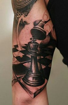 a man's arm with a chess piece on it