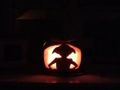 a pumpkin carved to look like a child's silhouette