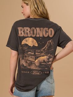 Rev up your style with the Ford Bronco Graphic Tee. Featuring a classic Bronco design, this tee offers a vintage vibe perfect for any adventurer. Ford Bronco Tshirt, Ford Bronco Apparel, Cute Western Shirt Ideas, Retro Outdoor Graphic Print T-shirt, Retro Graphic Print T-shirt For Outdoor, Retro Crew Neck T-shirt For Outdoor, Vintage Adventure Graphic T-shirt, Adventure Graphic Print Crew Neck Top, Vintage Graphic Print T-shirt For Adventure