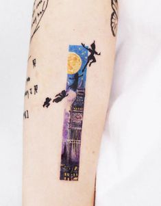 a person with a tattoo on their arm that has an image of the big ben clock tower