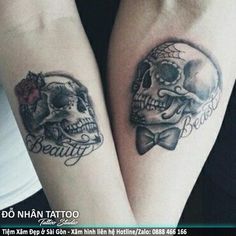 two skulls with bow ties on their arms, both have tattoos that read beauty and the beast