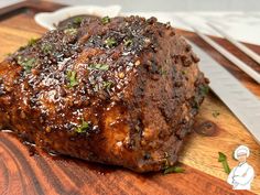 a piece of meat sitting on top of a wooden cutting board