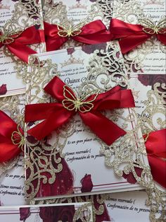 wedding cards with red bows and lace on them are laid out in the shape of a heart