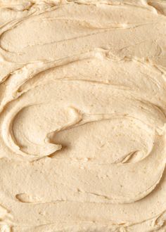 a close up view of a cake with white frosting on it's surface