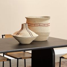 two vases sitting on top of a wooden table