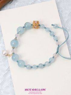 Inspired by the soothing hues of aquamarine, the Bravery Blue Aquamarine Bracelet captures the essence of courage and confidence. This exquisite bracelet features natural aquamarine beads, complemented by delicate rose quartz and gold-plated accents. Designed with an adjustable drawstring, it offers a perfect fit for anyone seeking to embrace the calming and empowering energy of aquamarine. This bracelet embodies the powerful properties of aquamarine, known as the Stone of Braveness and Fortune. Aquamarine Crystal Bracelet, Blue Aquamarine Bracelets For Gift, Blue Aquamarine Gemstone Beaded Bracelets, Spiritual Blue Aquamarine Beaded Bracelets, Speak Your Truth, Blue Aquamarine Beaded Bracelets, Spiritual Style, Aquamarine Bracelet, Magical Gift, Aquamarine Beads