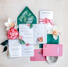 the wedding stationery is laid out on top of each other, including cards and envelopes