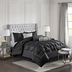 a black and white bed in a bedroom