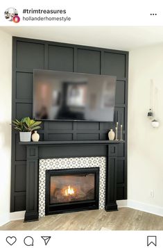 a fireplace with a flat screen tv mounted above it and a potted plant on the mantle