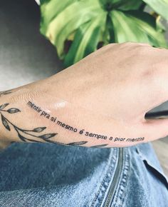 a person's foot with a tattoo on it and the words in latina