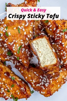 chicken wings with sesame seeds and parmesan cheese on a white plate, ready to be eaten