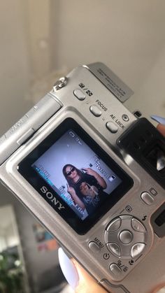 a person is holding up a camera to take a picture with the image on it