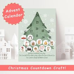 a christmas tree calendar is displayed on a table with white houses and snowflakes