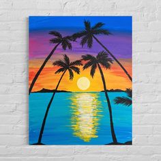 an acrylic painting of palm trees and the sun setting over water in front of a white brick wall