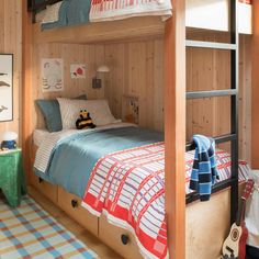 a bunk bed with two drawers underneath it in a child's playroom or bedroom