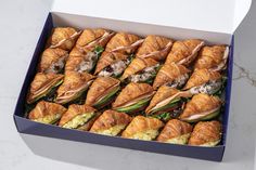 there are many croissants in the box that have been cut into pieces