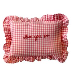 a red and white gingham pillow with the words love you so