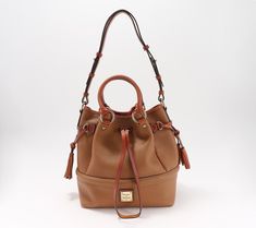 Choices, choices. This Dooney & Bourke pebble leather bag lets you decide -- on your shoulder, over your arm, or in your hand? Pull the drawstring tight or leave it loose? Take it to work or a weekend getaway? That question's easy -- both! From Dooney & Bourke. Fall Travel Shoulder Bag In Pebbled Leather, Fall Travel Pebbled Leather Shoulder Bag, Pebbled Leather Shoulder Bucket Bag For Travel, Pebbled Leather Satchel Bucket Bag For Travel, Pebbled Leather Crossbody Bucket Bag For Travel, Dooney & Bourke, Hobo Handbags, Weekend Getaway, Dooney Bourke