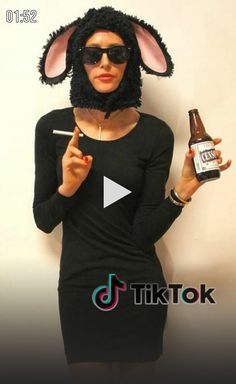 a woman in bunny ears holding a beer