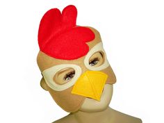 a chicken mask on top of a mannequin's head with an orange beak