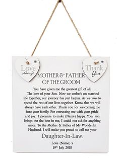 a hanging sign with two hearts attached to it that says, mother and father of the groom