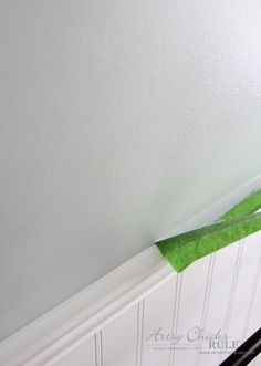 the corner of a room that has been painted white and is being held up by a pair of scissors