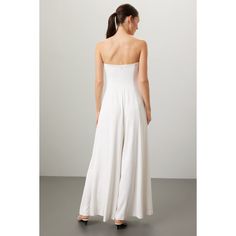 White crepe (97% Recycled Polyester, 3% Spandex). Jumpsuit. Sleeveless. Strapless. Back zipper closure. 57" from shoulder to hemline. Imported. Chic Summer Jumpsuits And Rompers With Back Zipper, White Fitted Strapless Sleeveless Jumpsuit, White Stretch Strapless Sleeveless Jumpsuit, Sleeveless Jumpsuit With Back Zipper For Spring, Sleeveless Spring Jumpsuits And Rompers With Back Zipper, Sleeveless Jumpsuits And Rompers With Back Zipper For Spring, Elegant Fitted Bandeau Jumpsuits And Rompers, Spring Evening Strapless Jumpsuit, Chic Strapless Elastane Jumpsuit