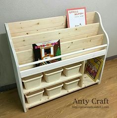 a book shelf made out of wood with bins and books on it's sides