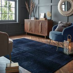 a living room with a blue chair and rug