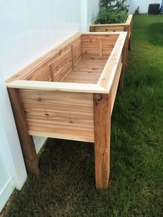 two wooden planters sitting in the grass