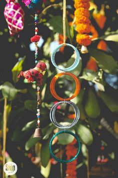 an assortment of colorful beads hanging from a tree