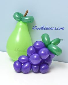 balloon grapes and a green pear on a table