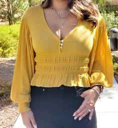 This ruffled cropped top features front button closures,  sexy v-neckline , smacked elastic waistband and cuffs and balloon sleeves. This mustard blouse is a must have. Wear with high wasted jeans for a non cropped look. Rayon Fit: True to size. Relaxed billowy fit. Moon And Stars Necklace, Mustard Blouse, High Wasted Jeans, Aqua Stone, Stars Necklace, Star And Moon Necklace, Gold Pendants, Cath Kidston, My Sunshine