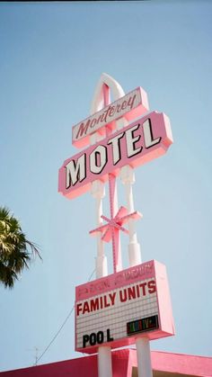 the neon motel sign is pink and white