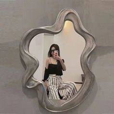 a woman taking a selfie in a mirror