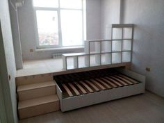 an empty bedroom with stairs leading up to the bed