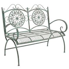 a metal bench with an intricate design on it's armrests and back