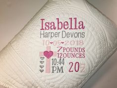 the birth pillow is decorated with pink and white designs on it's back side