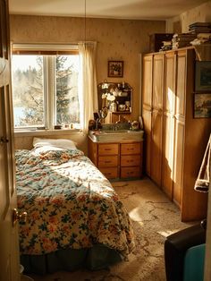 a bedroom with a bed, dresser and window in the corner that overlooks a lake