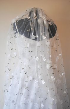 a wedding veil with white flowers on it