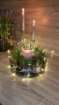 two candles are sitting on a glass plate